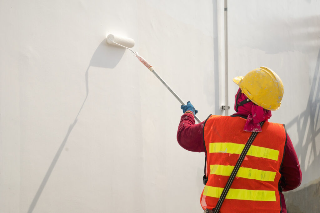 Construction worker painting a wall